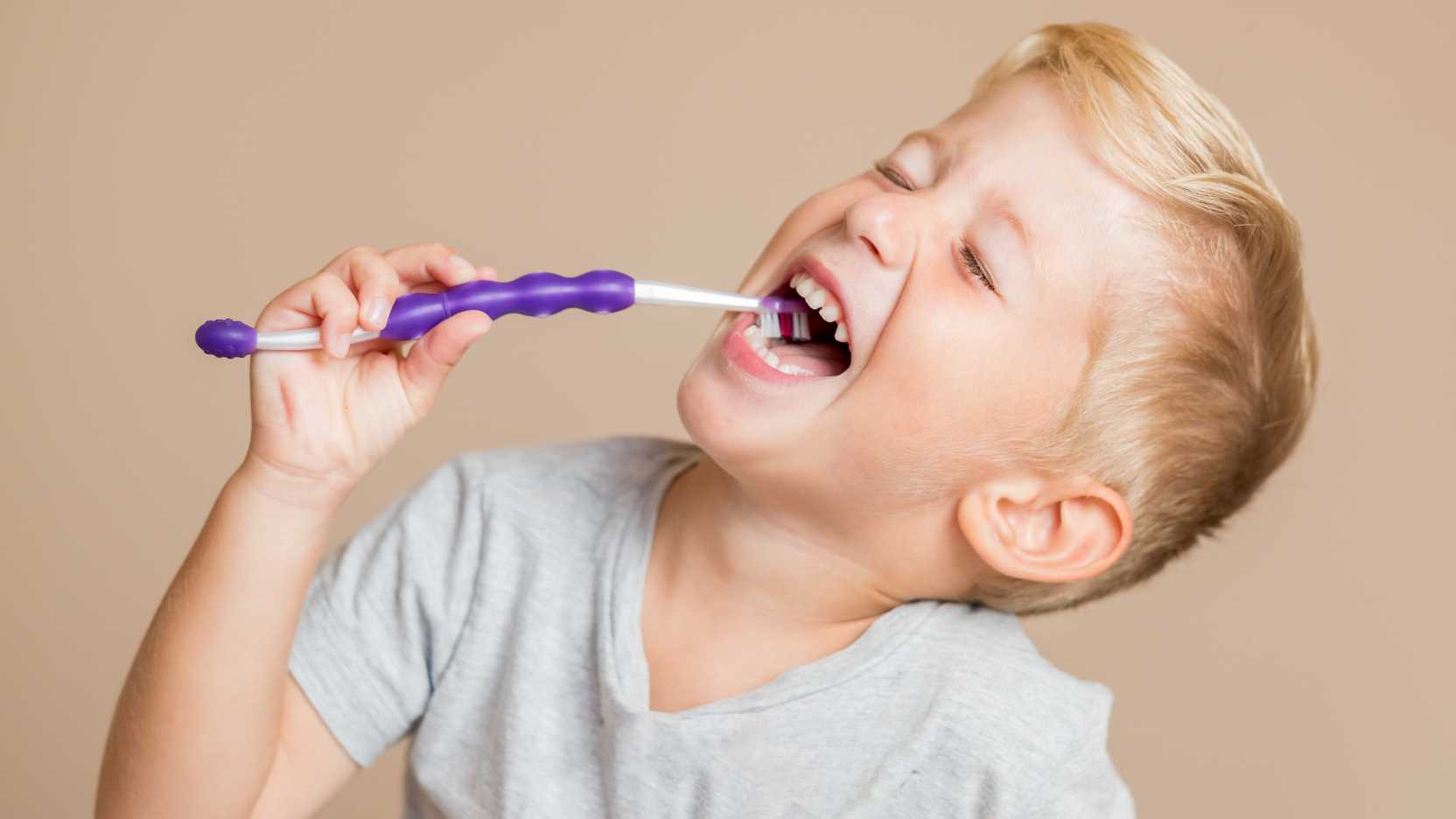 Child brushing teeth demonstrating autism daily living skills and hygiene routines