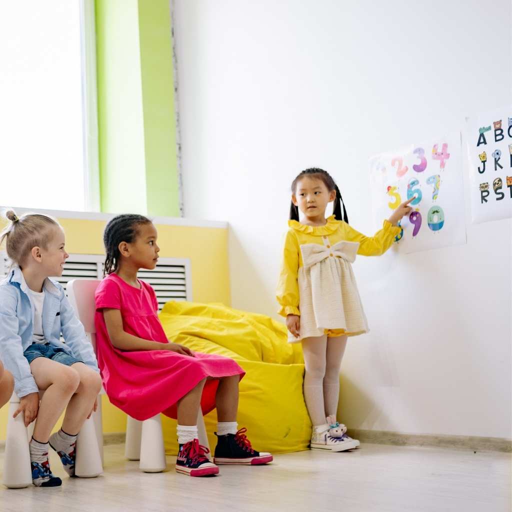 Kids in a playroom learning about numbers, illustrating ABA therapy and autism levels.