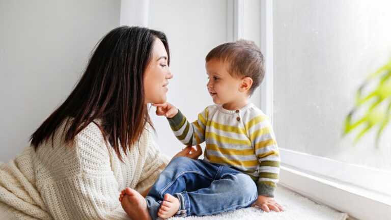 Toddler communicating with caregiver during ABA therapy for toddlers with autism