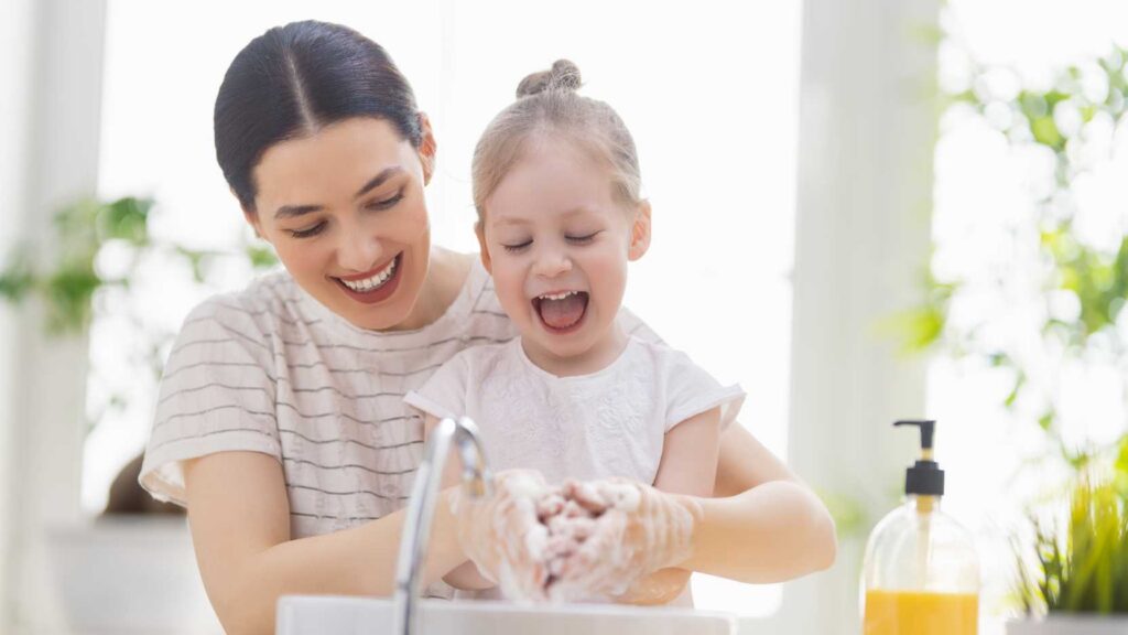 Parent teaching handwashing to a child with autism using guided support and ABA strategies