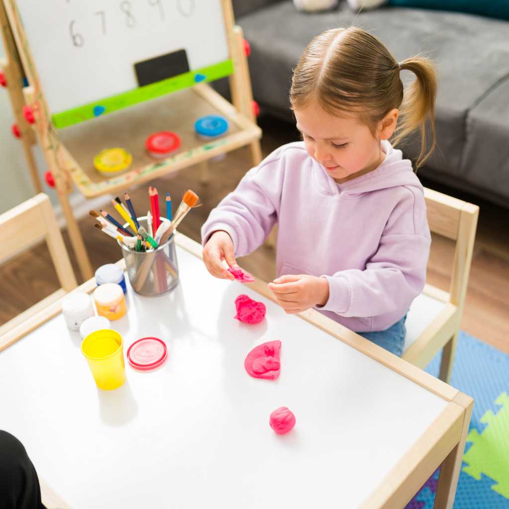 Toddler using playdough in ABA therapy for early learning